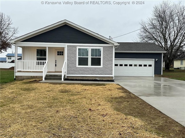 view of front of property with a front yard, a porch, and a garage