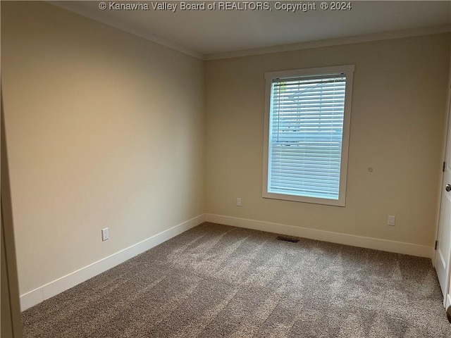 carpeted spare room with ornamental molding