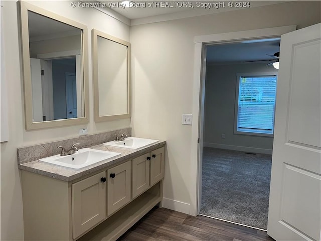 bathroom featuring crown molding, vanity, wood-type flooring, and ceiling fan