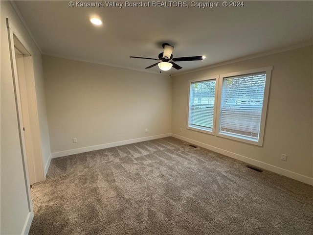 spare room featuring carpet flooring, ceiling fan, and crown molding