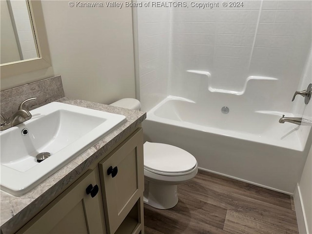 full bathroom featuring shower / bathing tub combination, wood-type flooring, vanity, and toilet