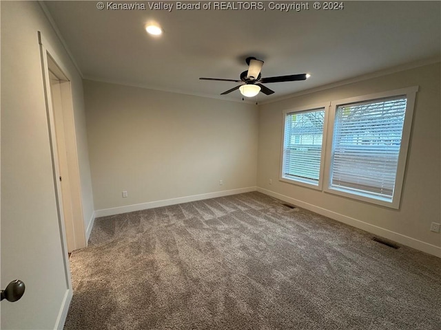 spare room with crown molding, carpet floors, and ceiling fan