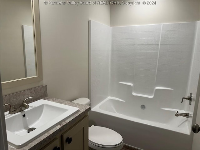 full bathroom with bathing tub / shower combination, vanity, and toilet