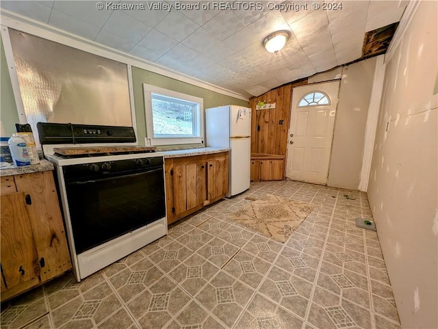 kitchen with lofted ceiling, light tile patterned flooring, white appliances, and ornamental molding