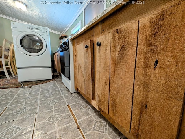 washroom featuring crown molding and washer / clothes dryer