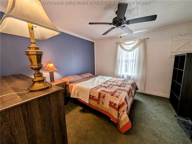 carpeted bedroom featuring ceiling fan and ornamental molding