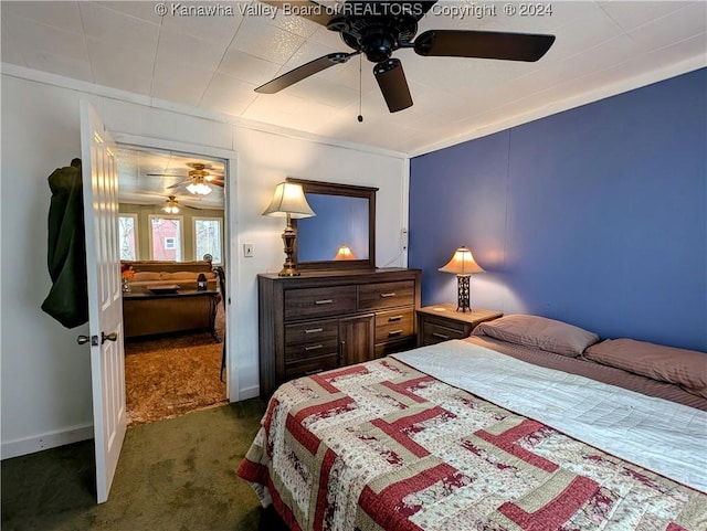 carpeted bedroom featuring ceiling fan and crown molding