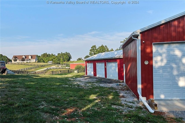 view of yard with a garage and an outdoor structure