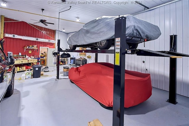 garage with ceiling fan and wooden walls