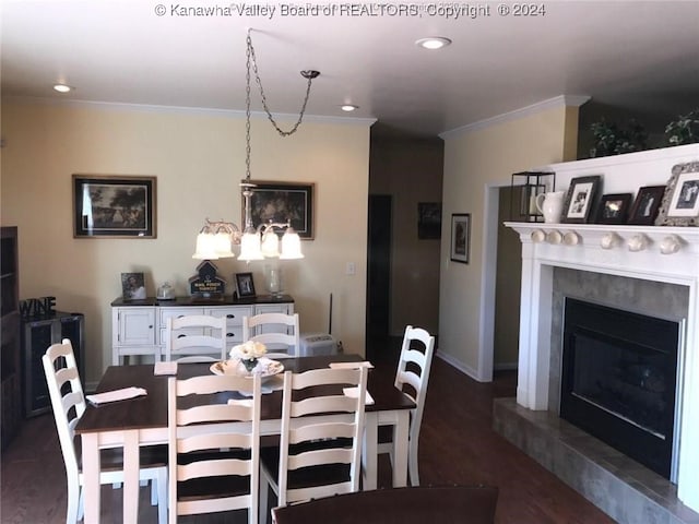 dining space featuring ornamental molding, a fireplace, and dark wood-type flooring