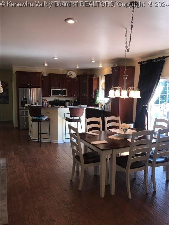 dining room featuring dark hardwood / wood-style flooring and a notable chandelier