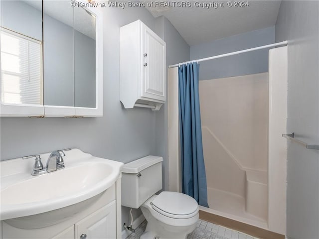 bathroom featuring vanity, curtained shower, and toilet