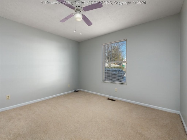 spare room with light carpet and ceiling fan