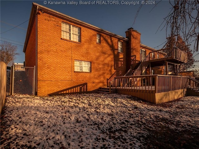 back of house featuring a wooden deck