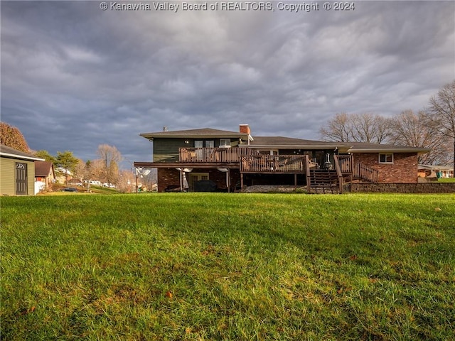 rear view of property featuring a lawn and a wooden deck