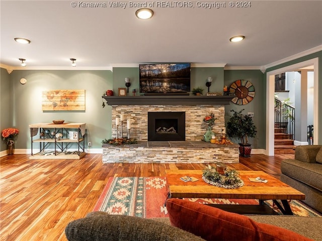 living room with a fireplace, hardwood / wood-style floors, and ornamental molding