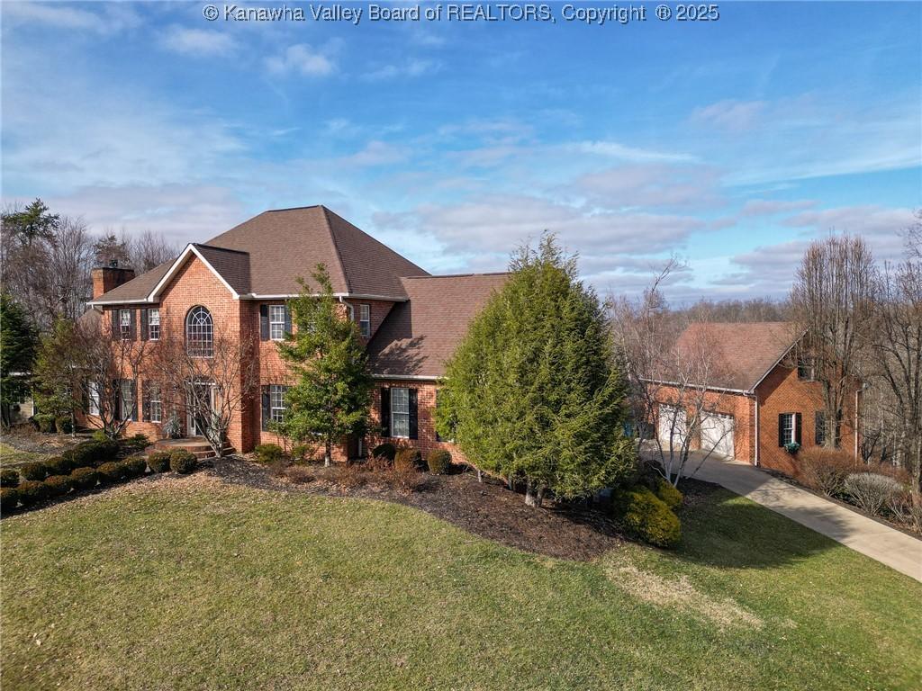 view of front of house with a garage and a front lawn