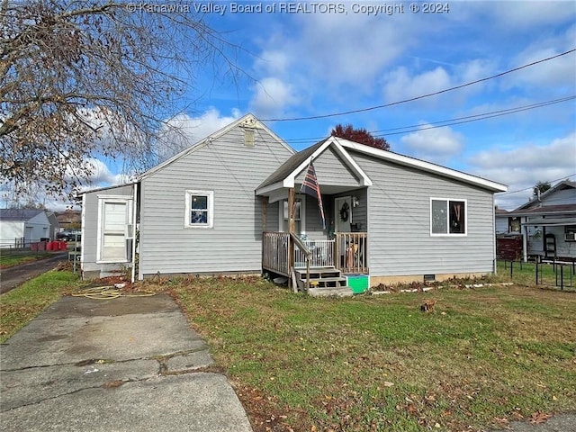 bungalow-style home featuring a porch and a front lawn