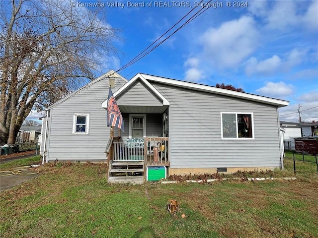 view of front of house with covered porch and a front yard