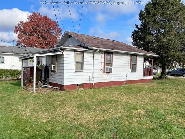 view of property exterior featuring cooling unit and a yard