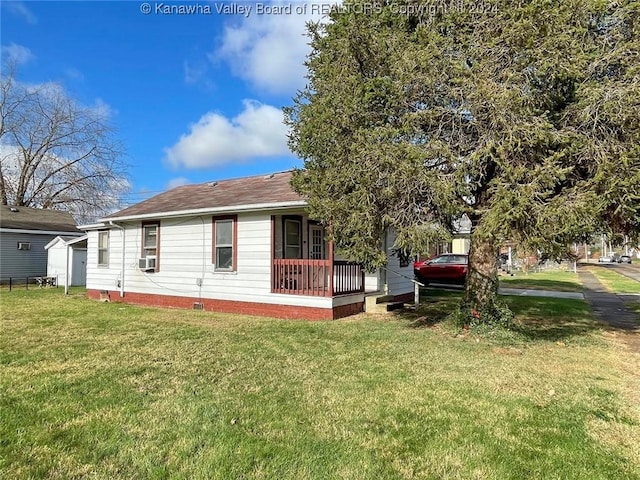 exterior space with cooling unit, a lawn, and covered porch