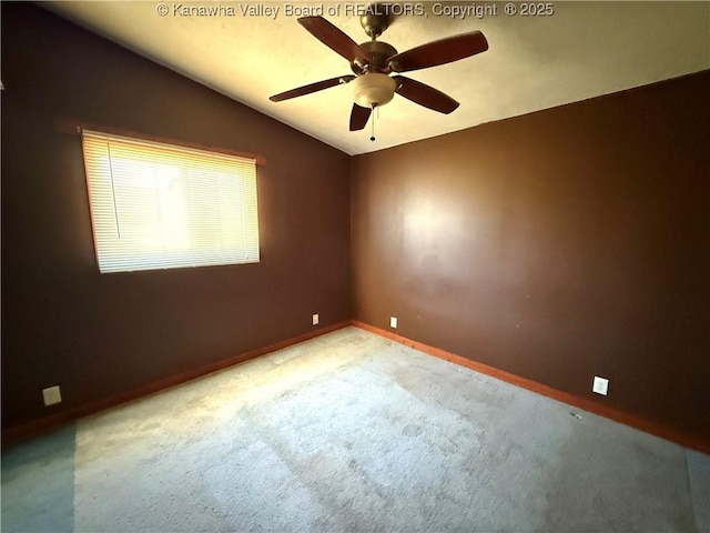 empty room featuring ceiling fan, light colored carpet, and lofted ceiling