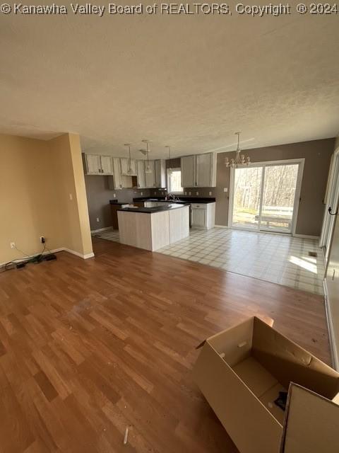 kitchen with hardwood / wood-style floors, a center island, and pendant lighting