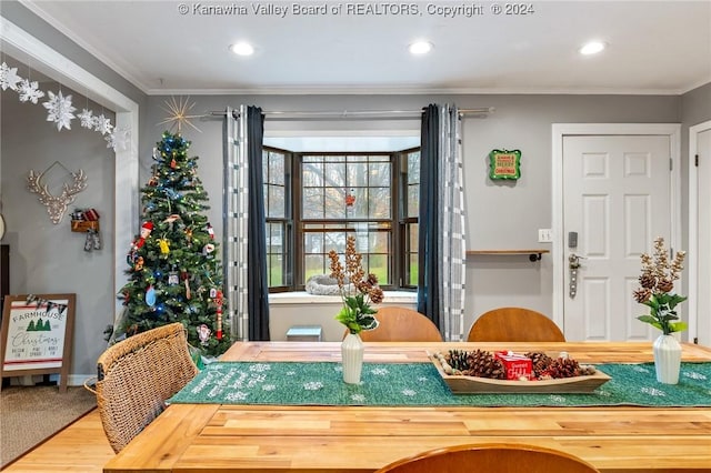 dining area with hardwood / wood-style floors and ornamental molding