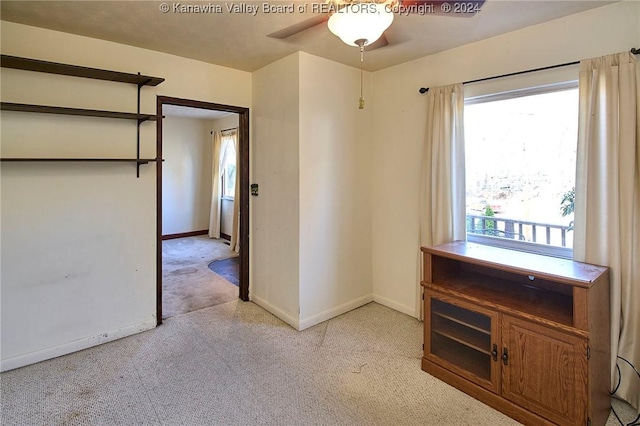 empty room with light colored carpet and ceiling fan