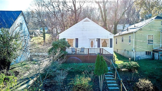 rear view of house featuring a deck