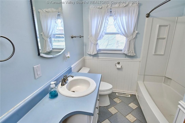 full bathroom with vanity, toilet, and  shower combination