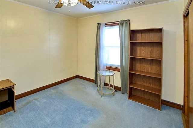 interior space with ceiling fan and crown molding