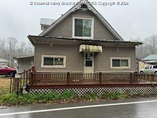 back of house featuring a wooden deck