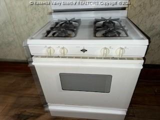 room details featuring white gas stove