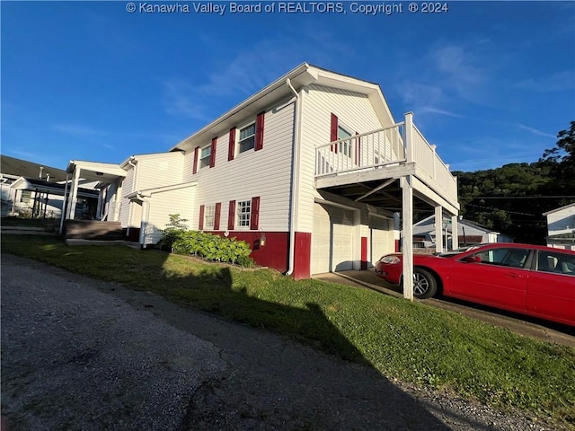 view of side of property with a balcony