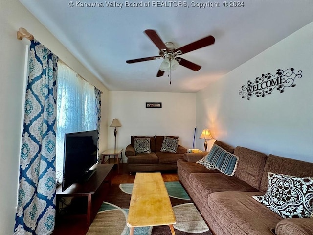 living room featuring hardwood / wood-style floors and ceiling fan