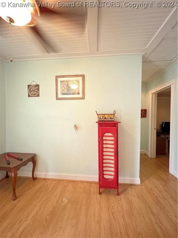 interior space with hardwood / wood-style floors and beam ceiling