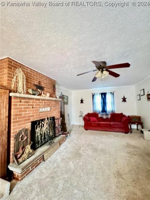 living room with ceiling fan, a fireplace, carpet, and a textured ceiling