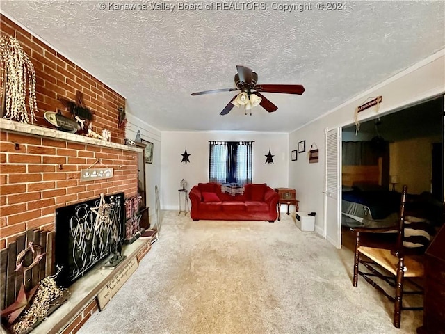 carpeted living room with ceiling fan, a textured ceiling, and a brick fireplace