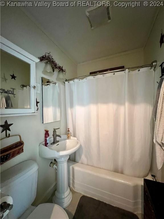 bathroom featuring shower / bath combo and toilet