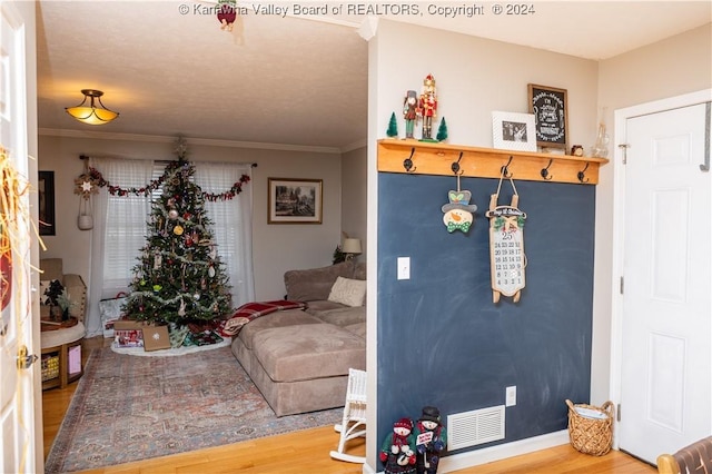 interior space featuring crown molding and hardwood / wood-style floors