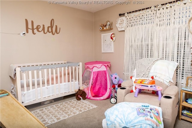 bedroom featuring carpet and a nursery area