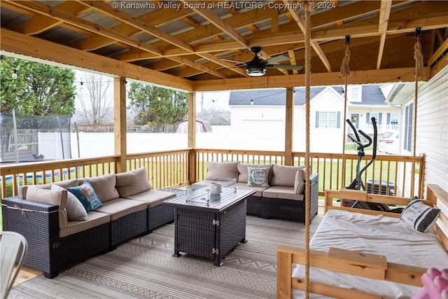 deck featuring outdoor lounge area and a trampoline