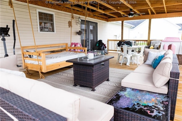 deck featuring an outdoor living space and ceiling fan