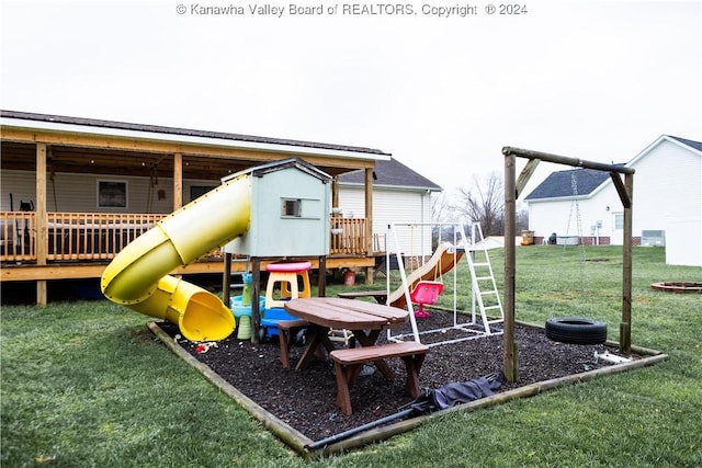 view of play area with a lawn and a wooden deck