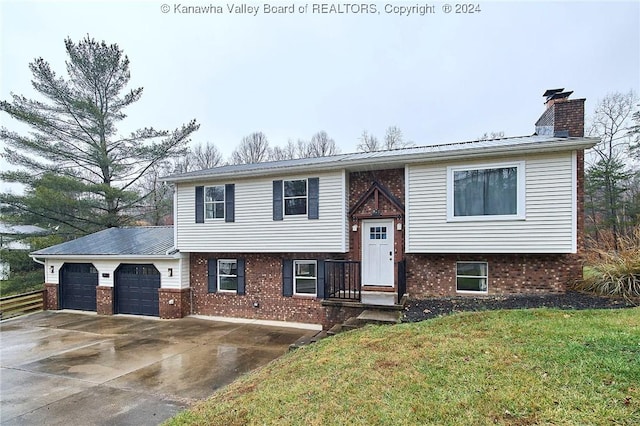 raised ranch with a front yard and a garage