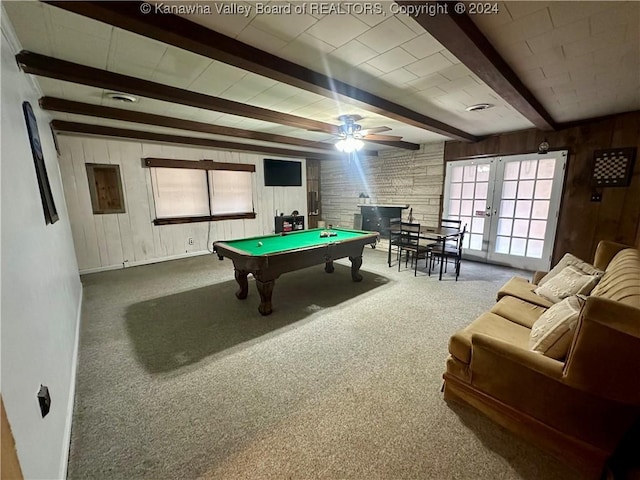 recreation room featuring beam ceiling, carpet floors, and wooden walls