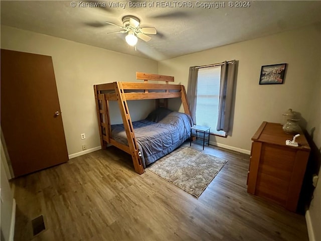 bedroom with ceiling fan and dark hardwood / wood-style floors