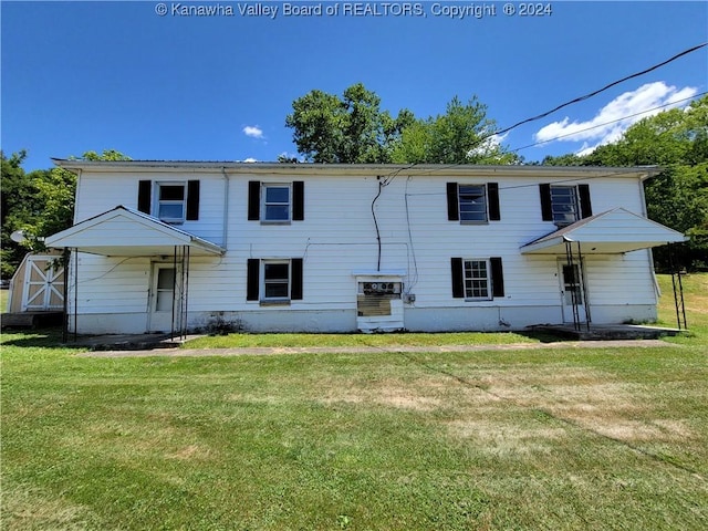 rear view of house with a yard