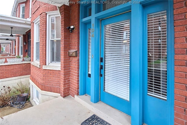 view of exterior entry with brick siding